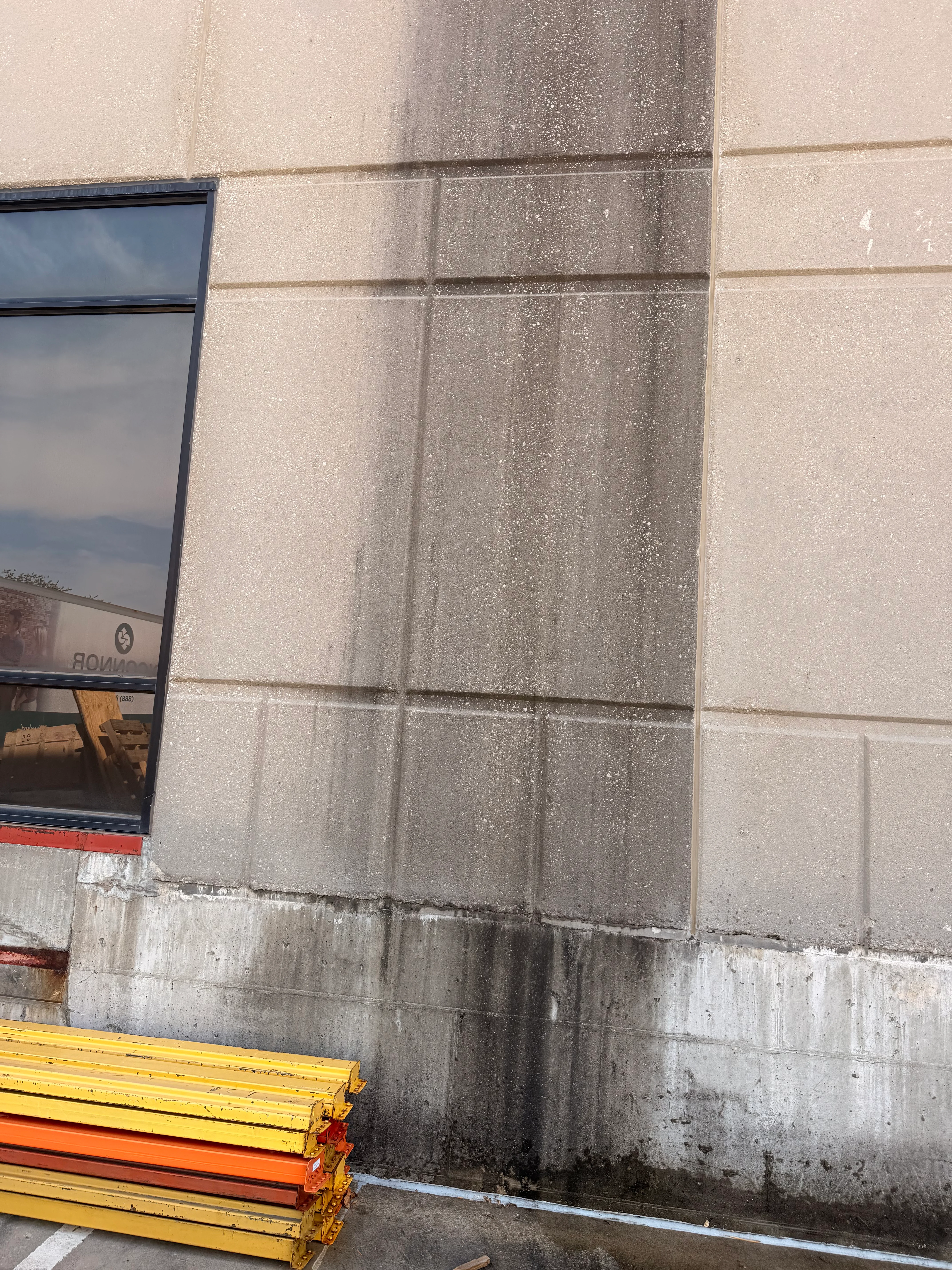 Concrete facade panels before and after pressure washing, algae and mold removal