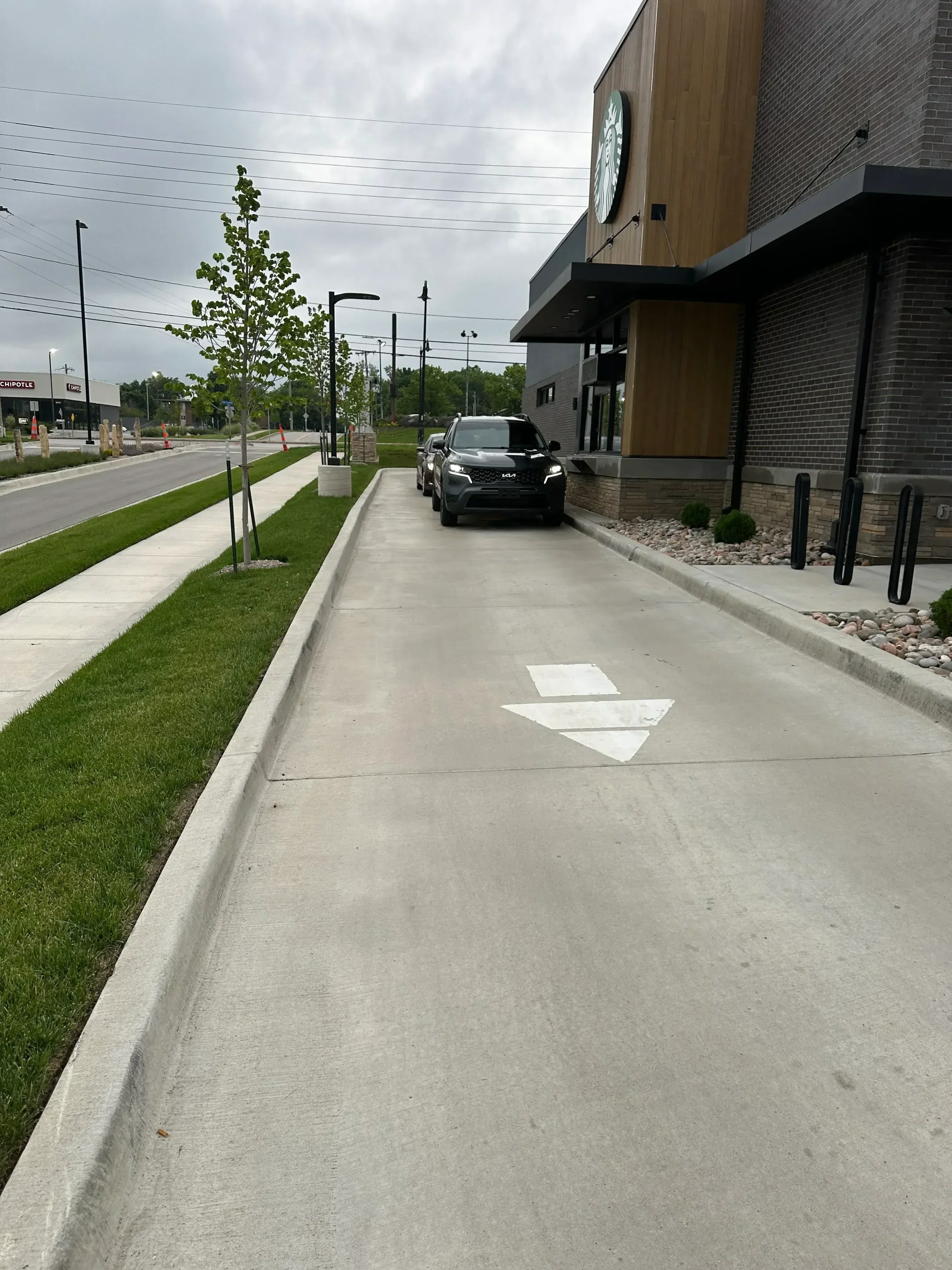 Cleaned concrete building exterior wall with green lawn and landscaping below