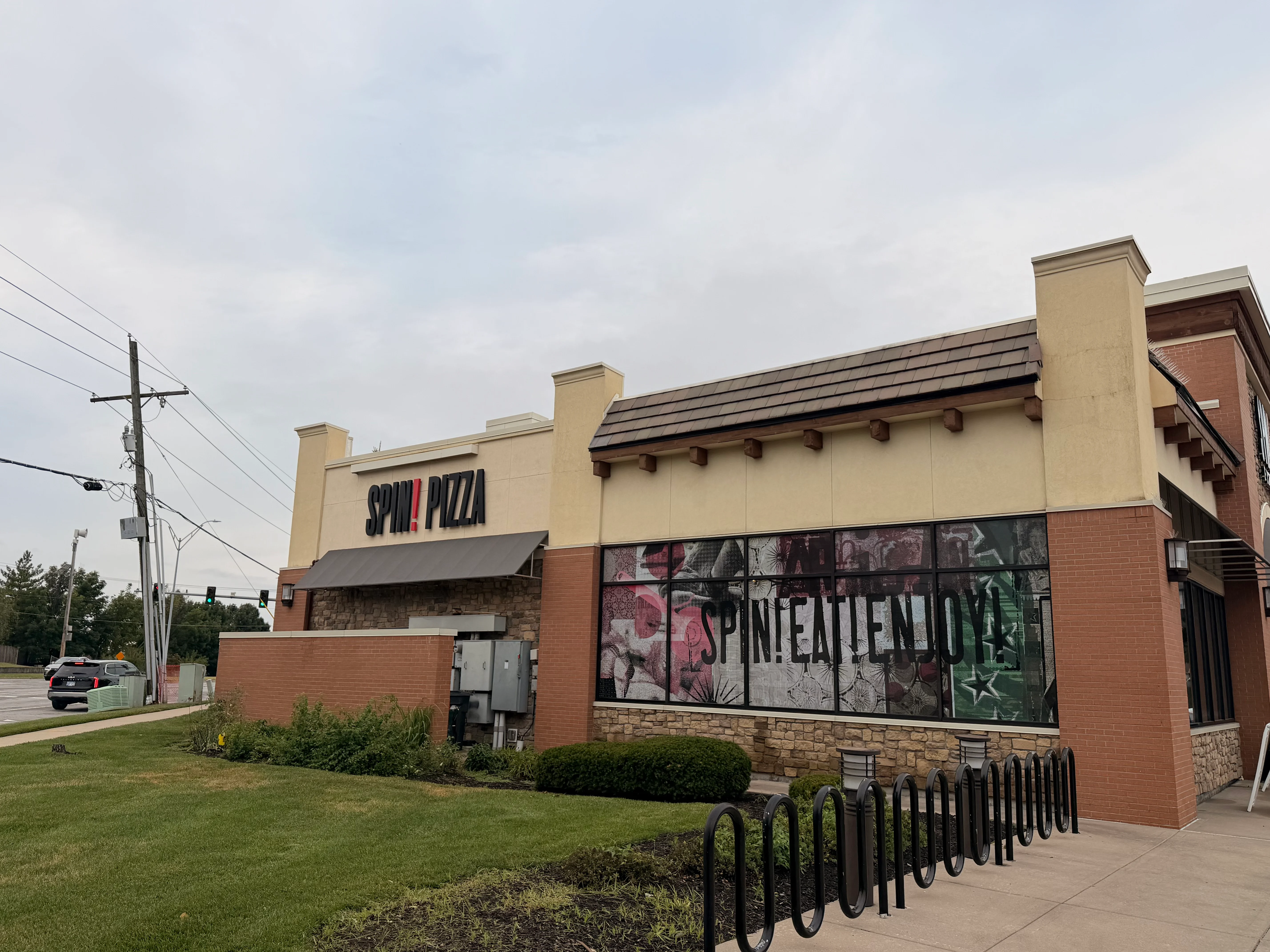 Clean brick and stone commercial building facade with restored storefront windows and signage
